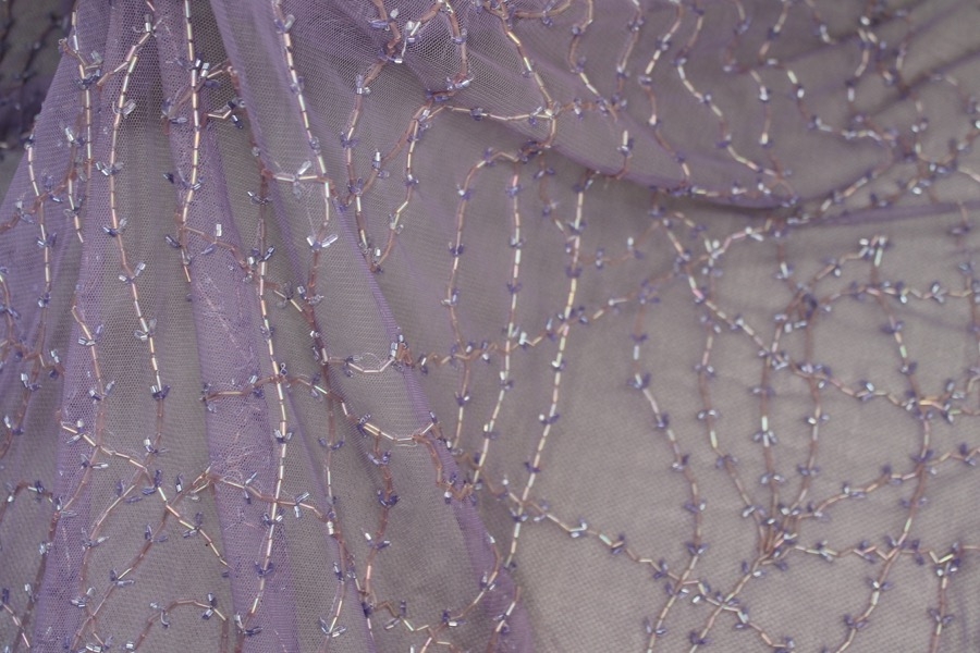 Lilac tulle with clear lilac bugle beads in a barbed wire/leaf pattern