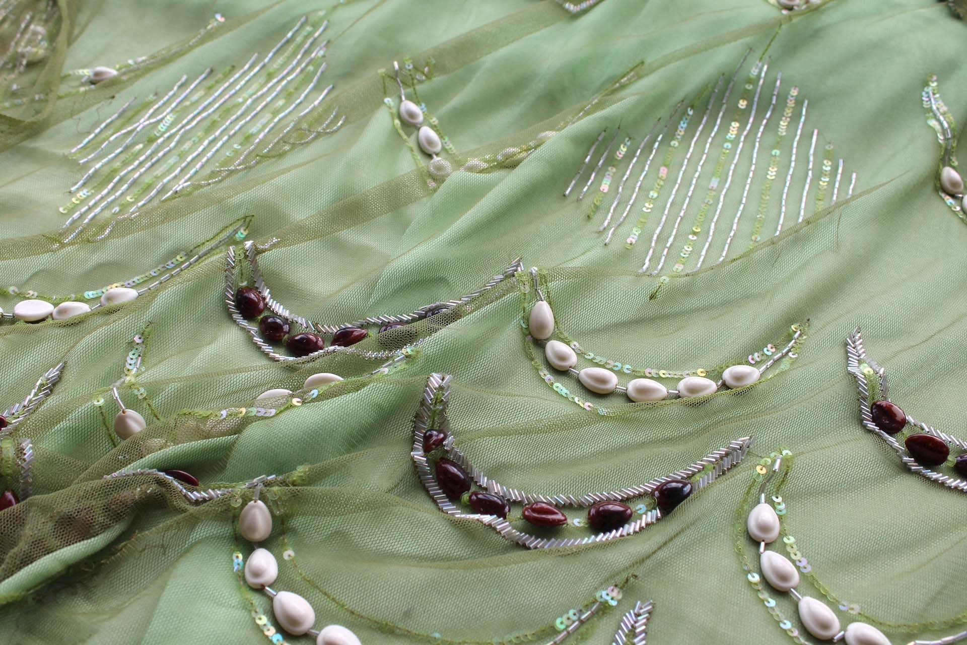 Green Tulle with Beads, Sequins and White and Brown Shells fabric