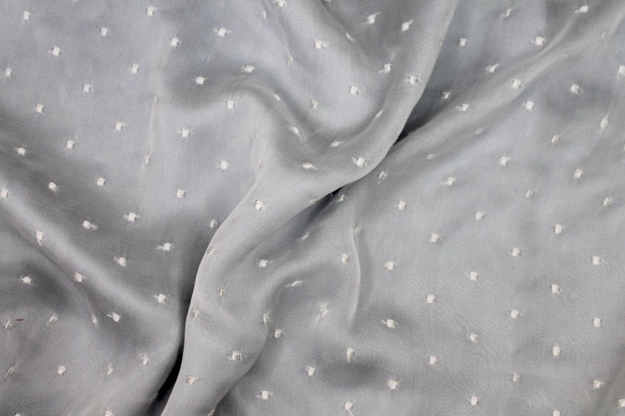 Photographed on a pale blue satin background cloth