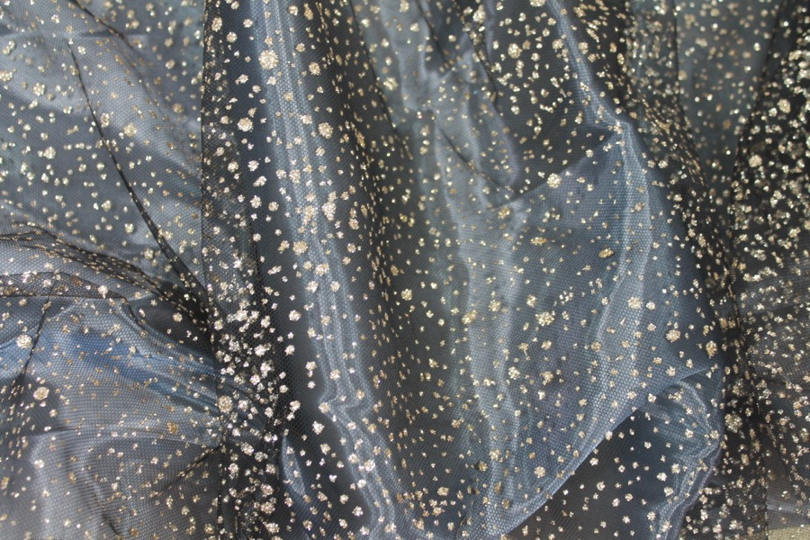 Photographed on a bluish grey organza