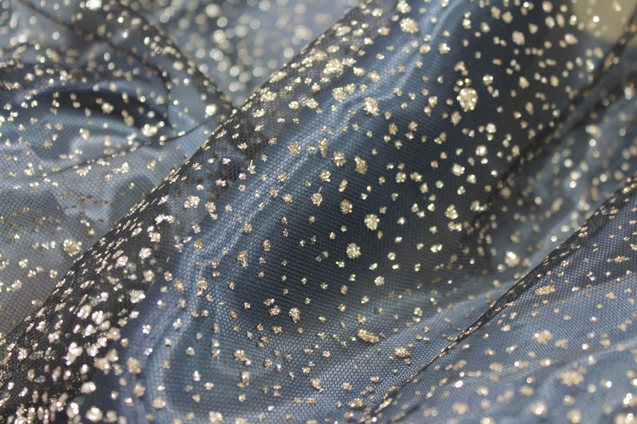 Photographed on a bluish grey organza