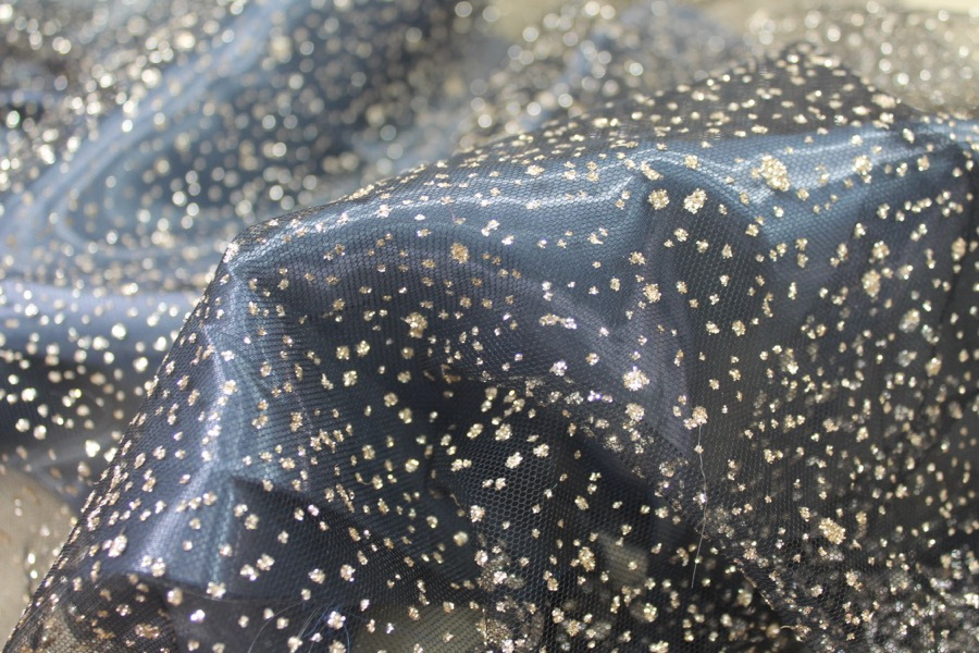 Photographed on a bluish grey organza