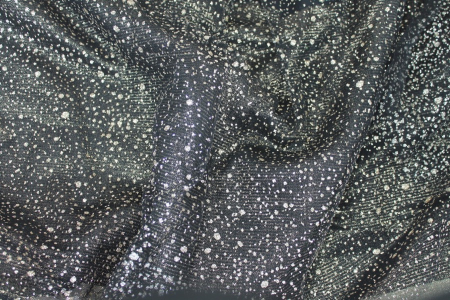 Photographed on a black and goldfabric