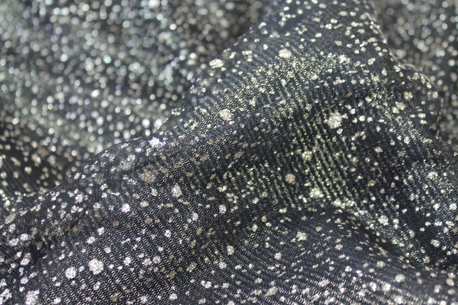 Photographed on a black and gold fabric