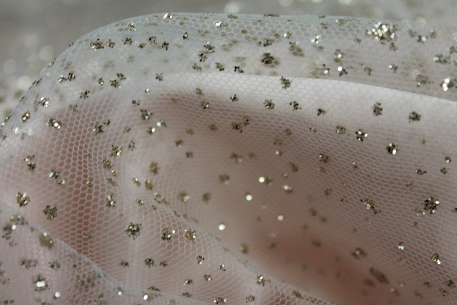 Photographed on a pale pink satin fabric