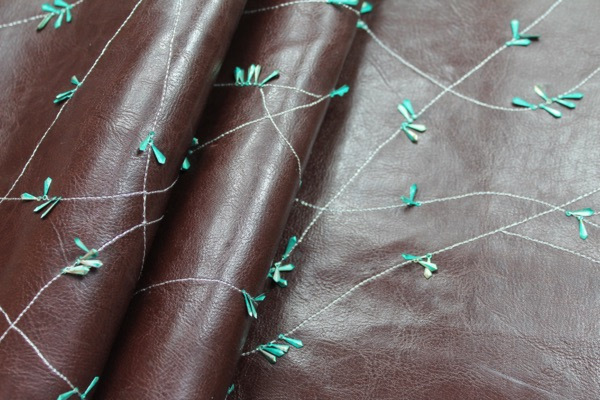 Embellished Leatherette - Brown with Teal Metal Sequins fabric