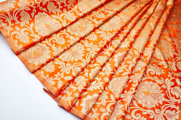 Heavy Banaras Brocade in an Orange and Gold Swirl Pattern fabric