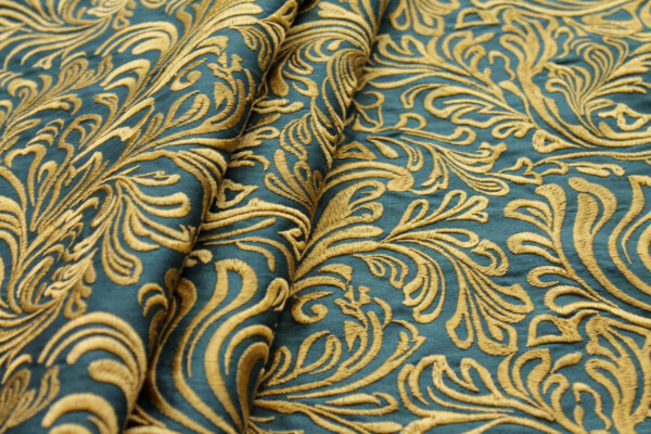 Swirly Embroidered Dupion - Gold on Teal fabric
