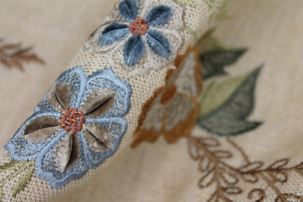 Floral Embroidered Linen in Blue, Orange and Greens on Cream fabric